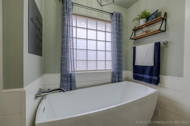 bathroom featuring a tub to relax in