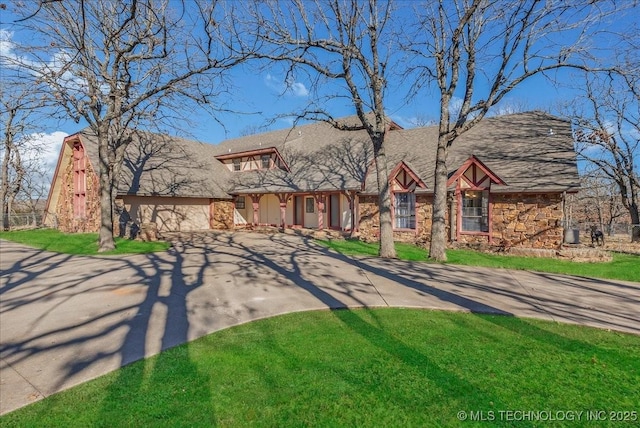 tudor-style house featuring a front yard