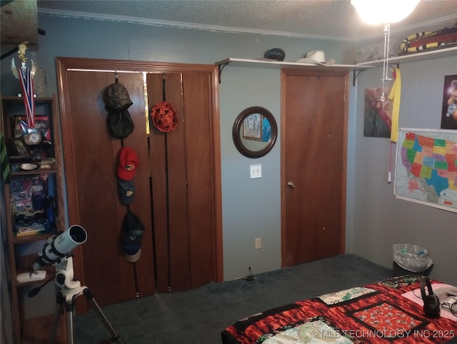 bedroom with carpet floors and a textured ceiling