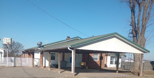 back of property with a carport