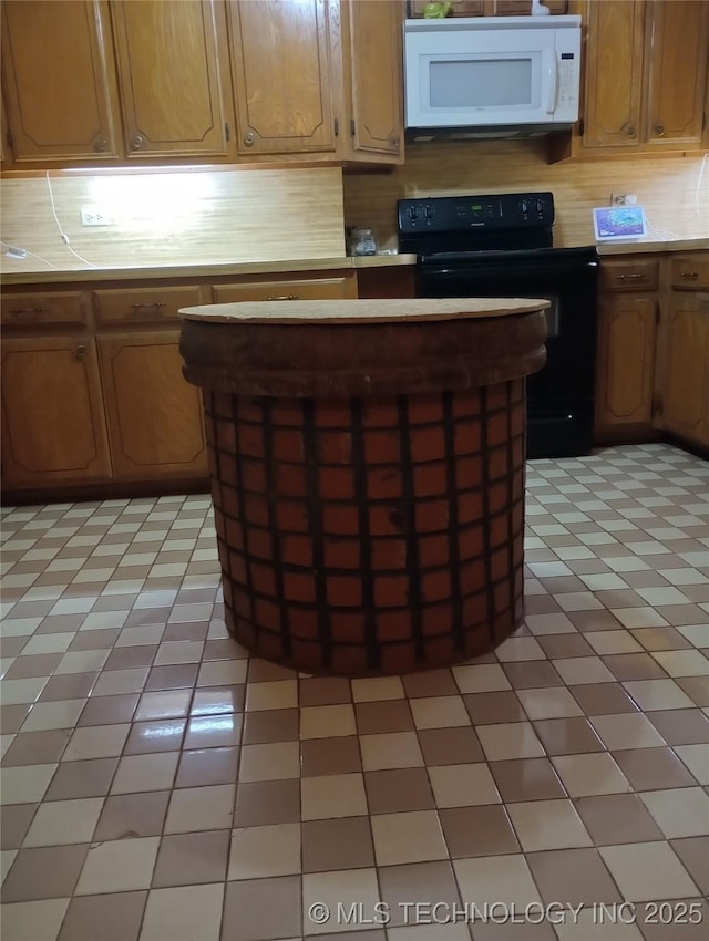 kitchen featuring electric range and light tile patterned flooring