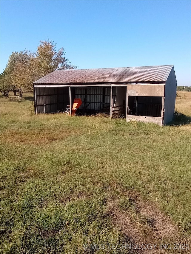 view of stable with a rural view