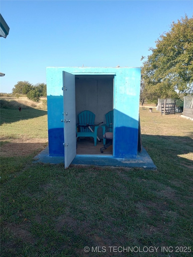 view of outbuilding featuring a lawn