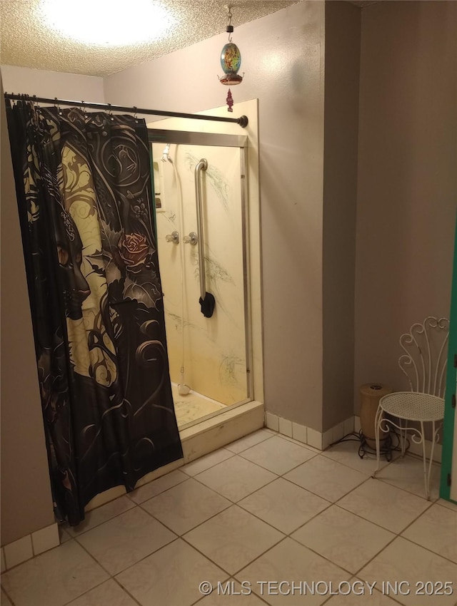 bathroom featuring curtained shower, a textured ceiling, and tile patterned floors