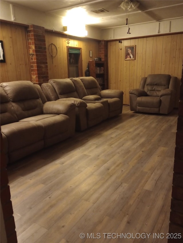 living room with wood-type flooring and wood walls