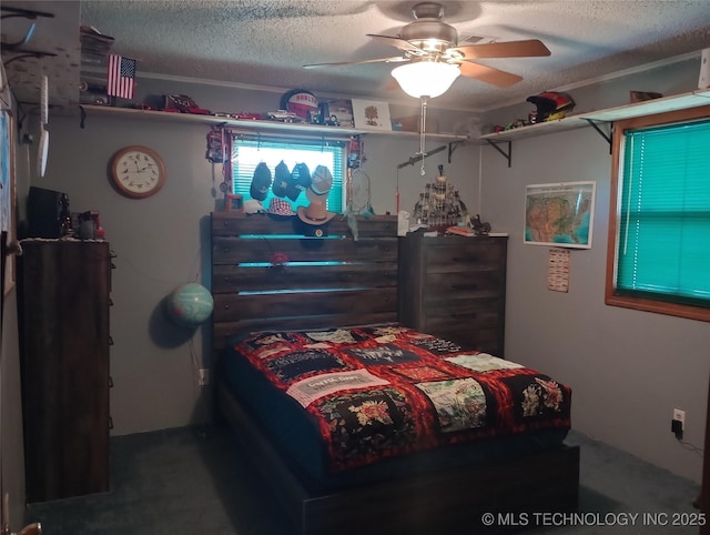 bedroom with ceiling fan and a textured ceiling