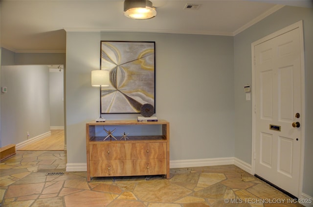 foyer entrance featuring crown molding