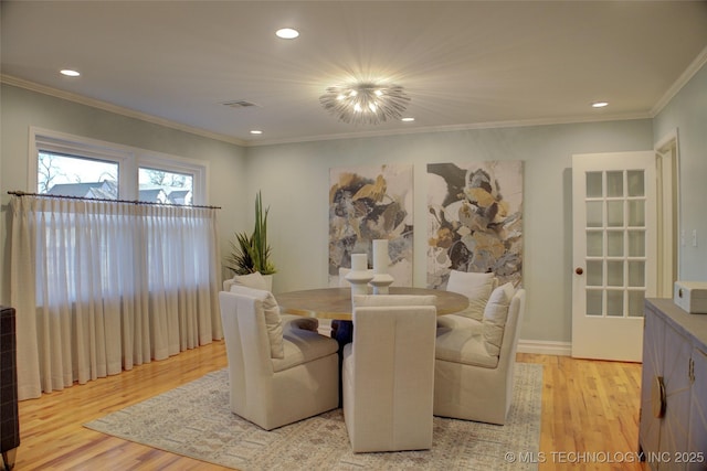 living room with light wood-type flooring and crown molding