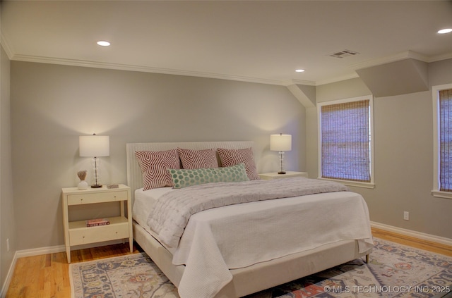 bedroom with crown molding and hardwood / wood-style flooring