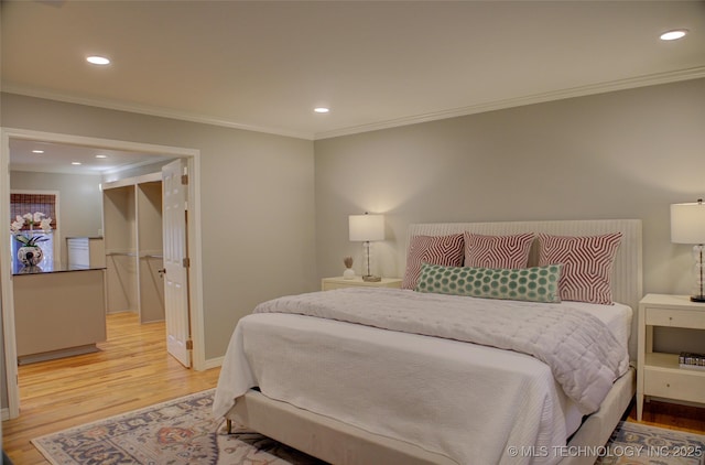 bedroom featuring ornamental molding and light hardwood / wood-style flooring