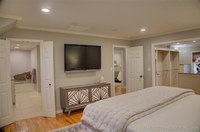 bedroom featuring ornamental molding and light wood-type flooring