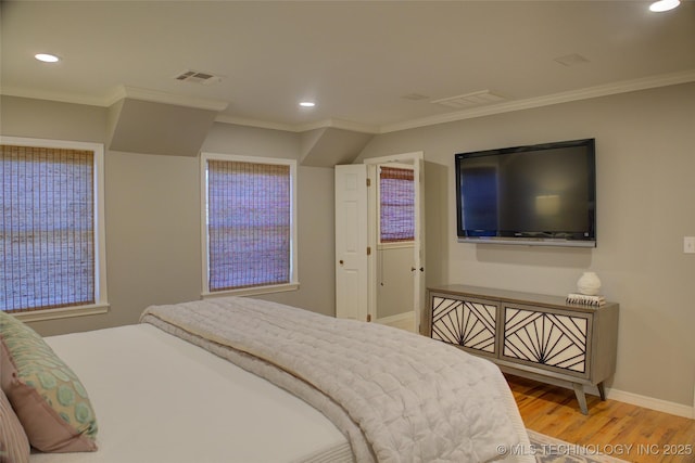 bedroom with crown molding and hardwood / wood-style flooring