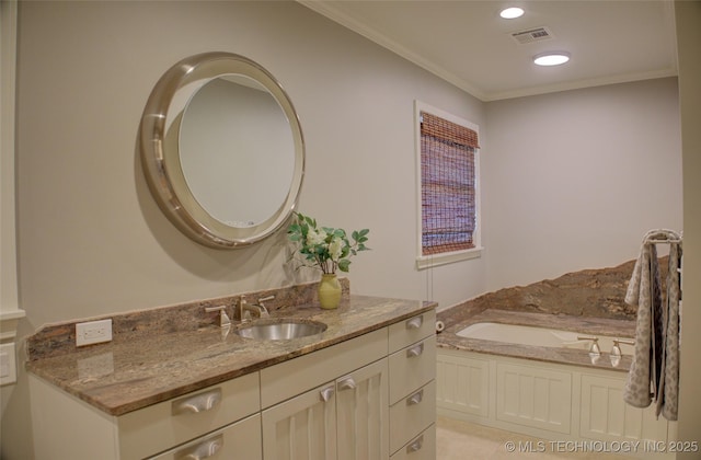 bathroom featuring a bathtub, vanity, and ornamental molding