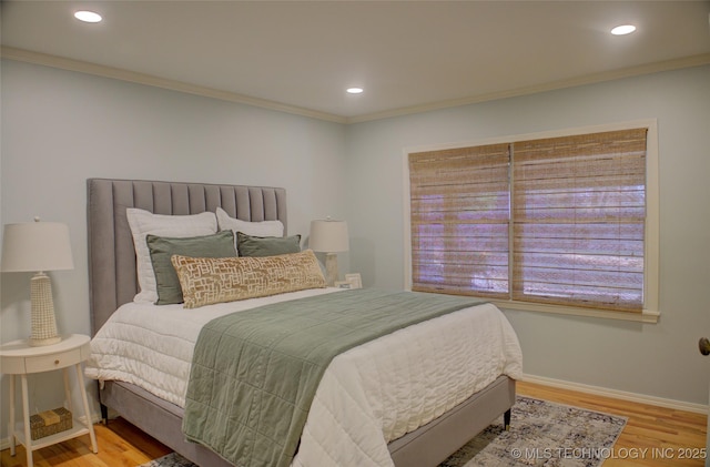 bedroom featuring hardwood / wood-style floors and crown molding