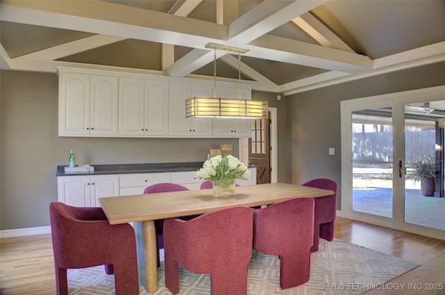 dining area featuring light hardwood / wood-style flooring, french doors, and vaulted ceiling with beams