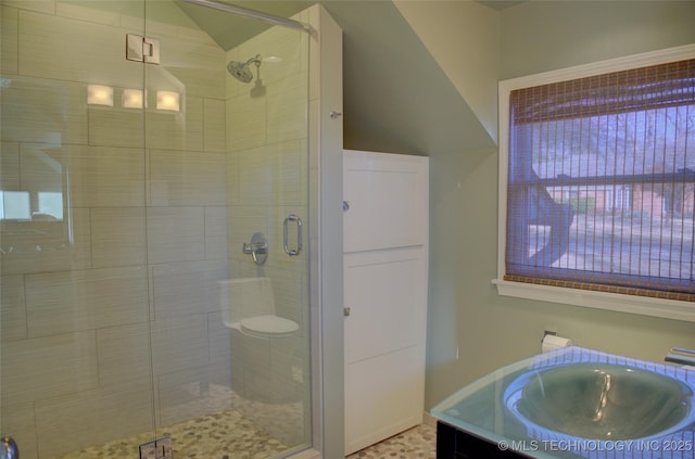 bathroom featuring walk in shower and vanity