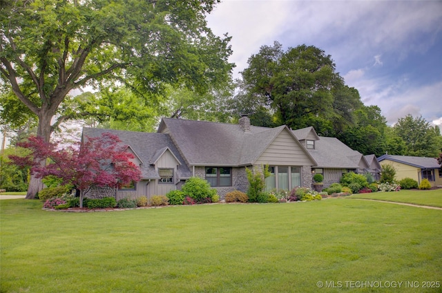 view of front of home featuring a front yard, a chimney, board and batten siding, and stone siding