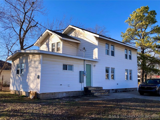 back of property with entry steps and crawl space