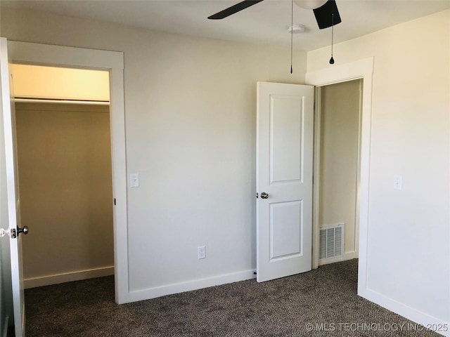 unfurnished bedroom with dark colored carpet, ceiling fan, and a closet