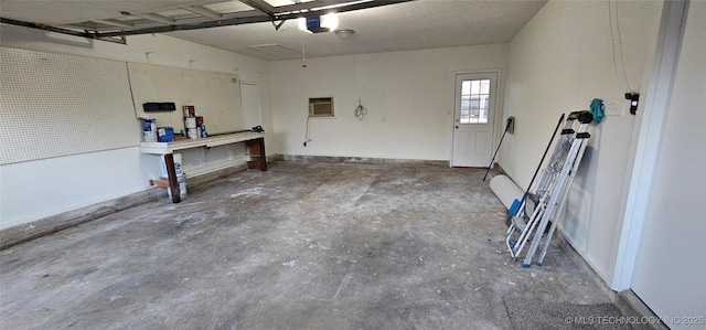 garage featuring a garage door opener and an AC wall unit