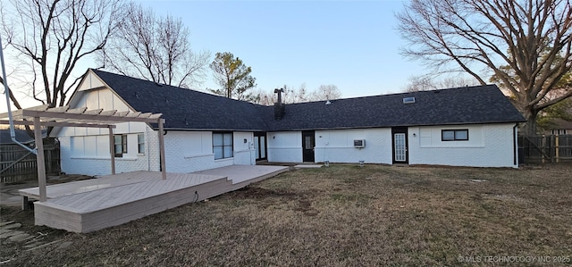 back of house with a pergola, a deck, and a yard