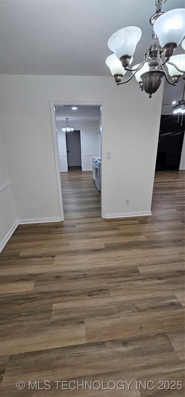 unfurnished dining area featuring a notable chandelier and dark hardwood / wood-style flooring