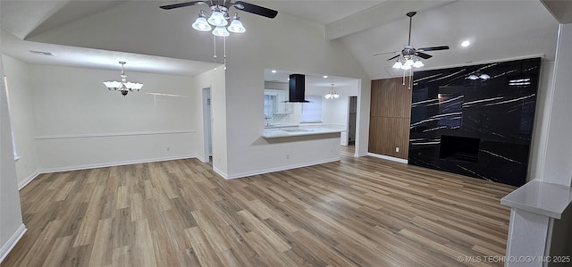 unfurnished living room featuring ceiling fan with notable chandelier, wood-type flooring, and lofted ceiling with beams