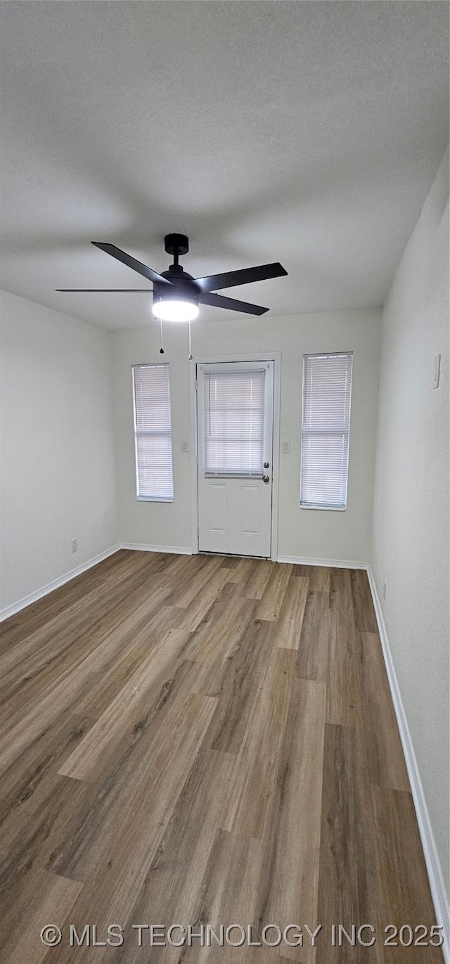 spare room with hardwood / wood-style floors and a textured ceiling