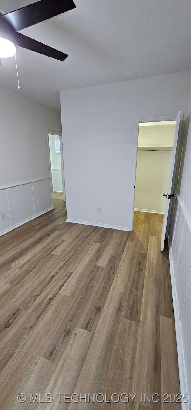 unfurnished room with hardwood / wood-style flooring and ceiling fan