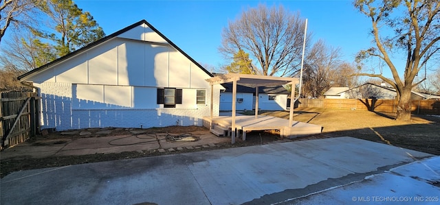 rear view of house featuring a pergola and a patio area