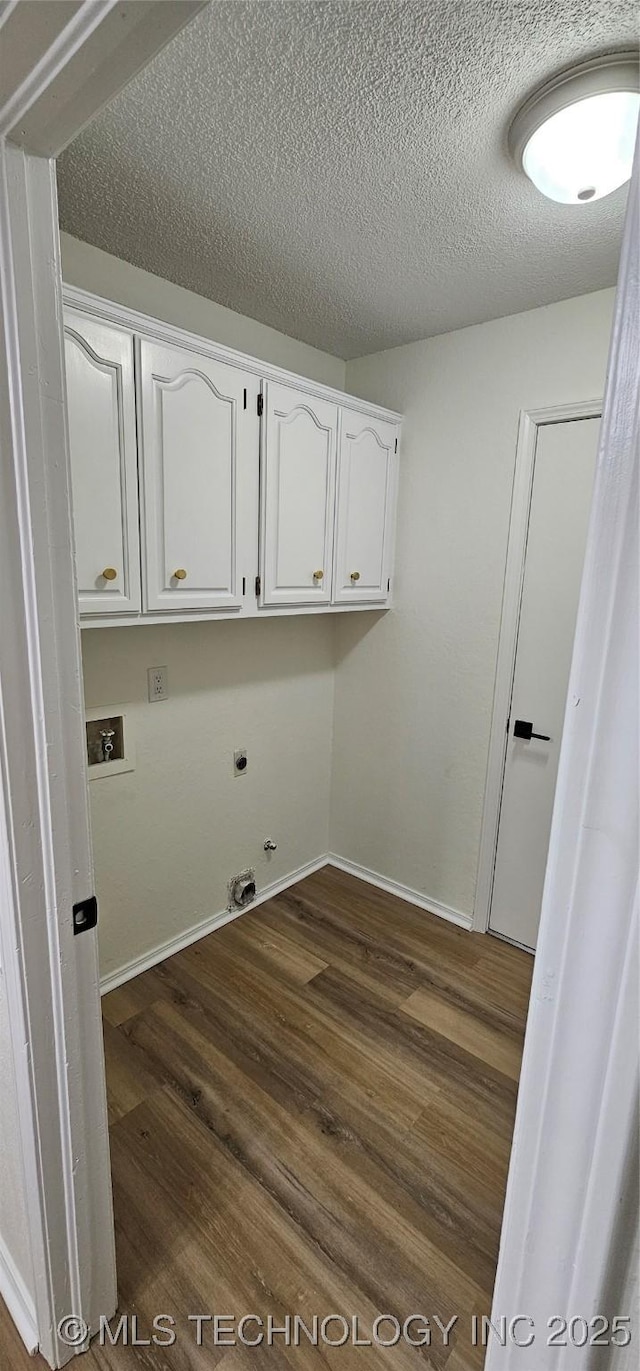 laundry area featuring gas dryer hookup, washer hookup, dark hardwood / wood-style flooring, electric dryer hookup, and cabinets