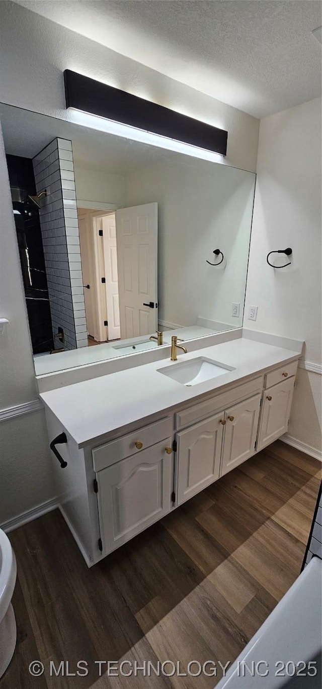 bathroom featuring hardwood / wood-style flooring, a textured ceiling, and vanity