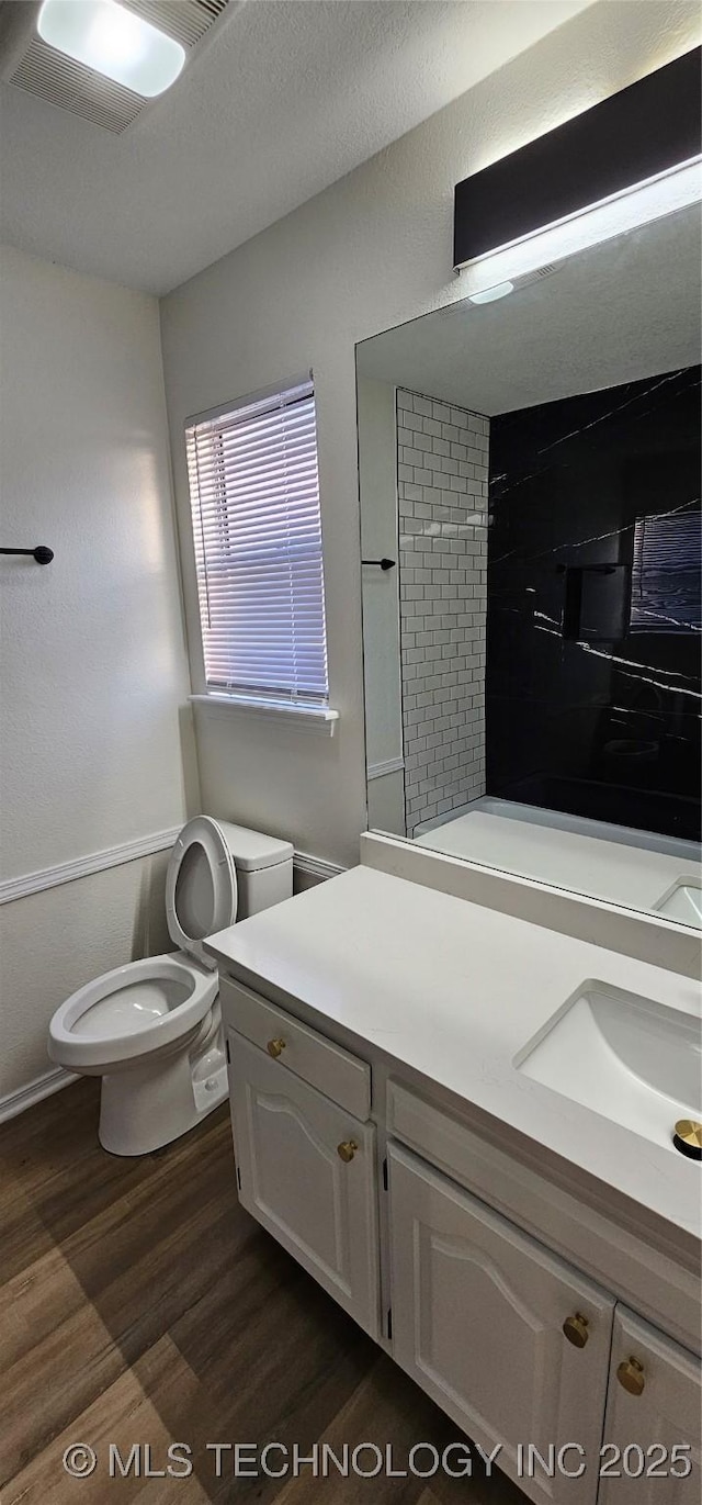 bathroom featuring hardwood / wood-style floors, toilet, and vanity