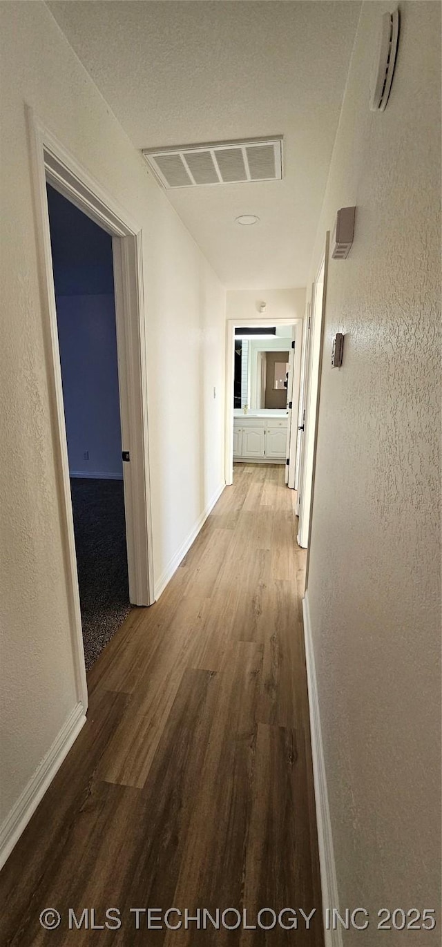 corridor with wood-type flooring