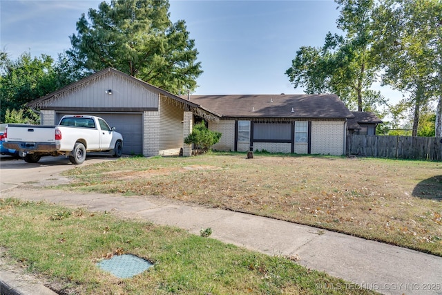 ranch-style home featuring a garage and a front lawn