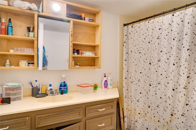 bathroom featuring vanity and a shower with shower curtain