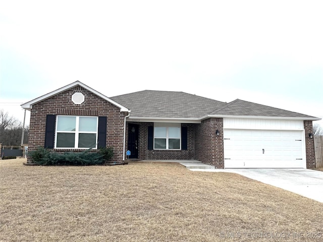 ranch-style home featuring a garage and a front lawn