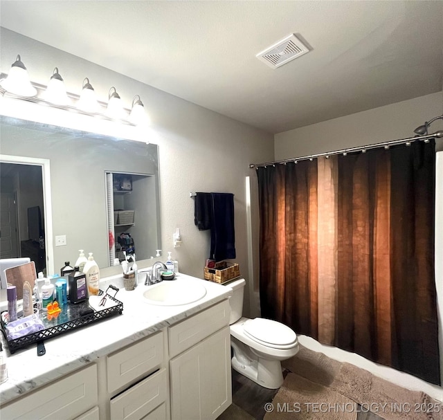 bathroom featuring toilet and vanity