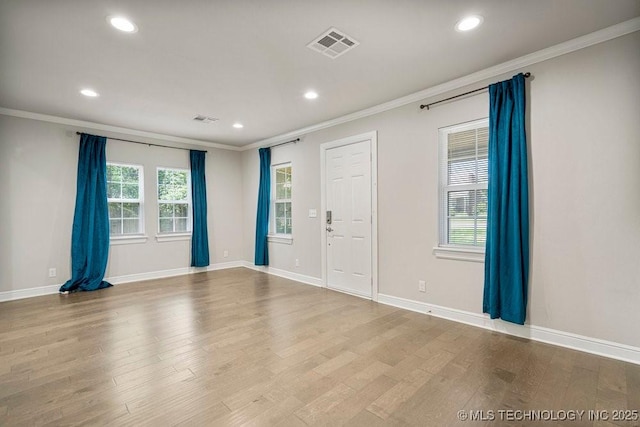 unfurnished room featuring light wood-type flooring and crown molding