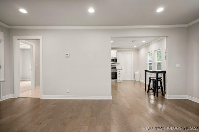 living room with ornamental molding and hardwood / wood-style flooring