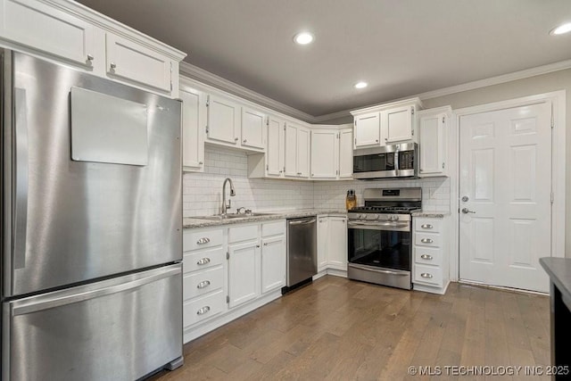 kitchen featuring tasteful backsplash, sink, appliances with stainless steel finishes, white cabinets, and light stone counters