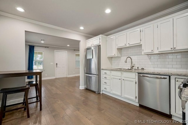 kitchen with stainless steel appliances, dark hardwood / wood-style floors, light stone countertops, white cabinets, and sink