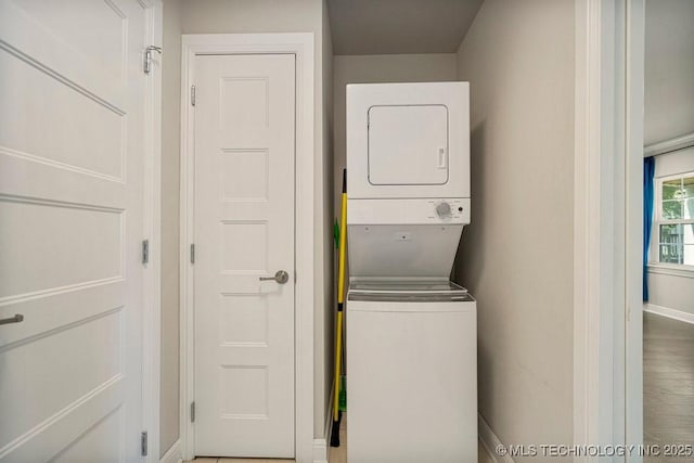 laundry area featuring stacked washer and clothes dryer