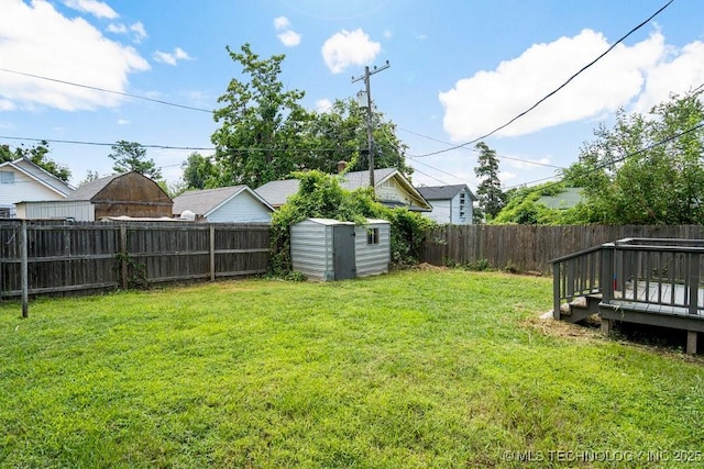 view of yard featuring a deck and a storage unit