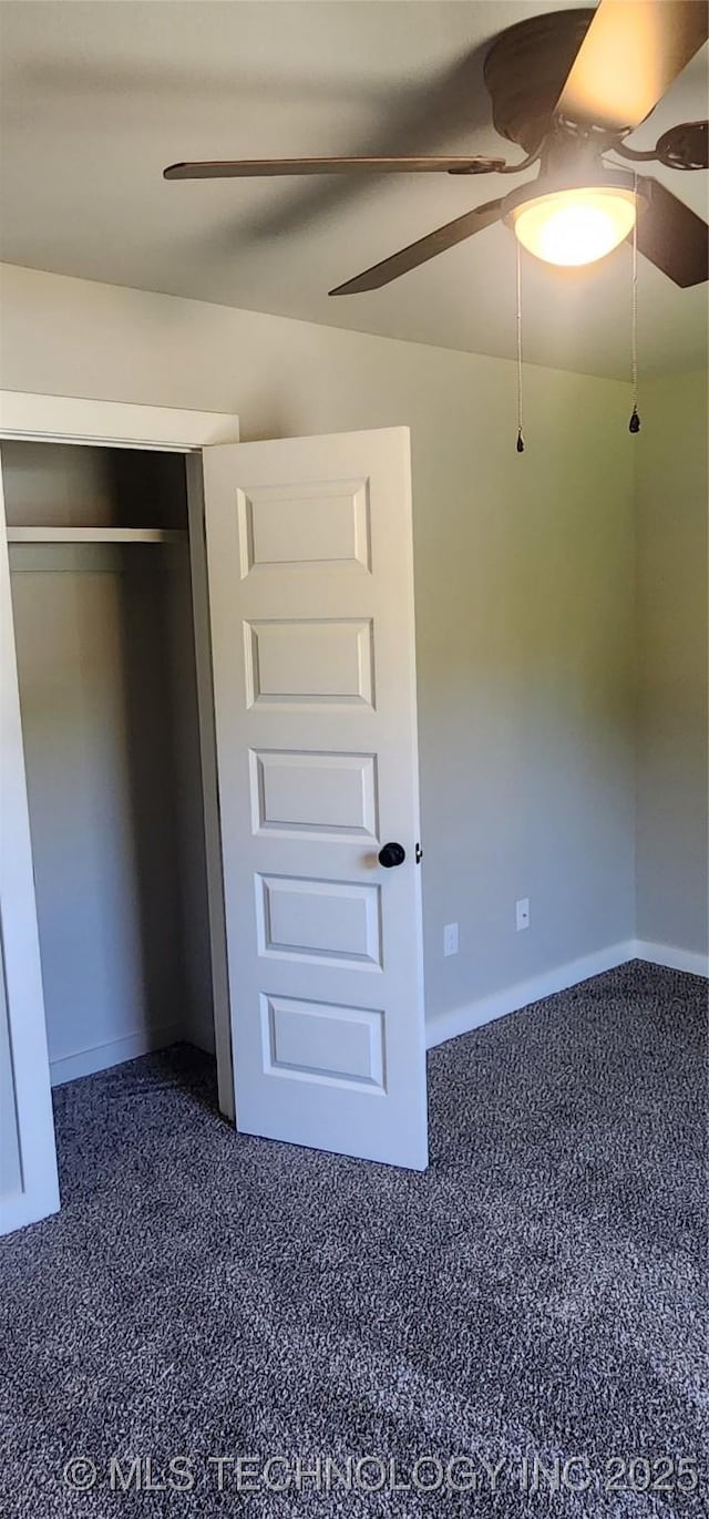 unfurnished bedroom with ceiling fan, carpet, and a closet