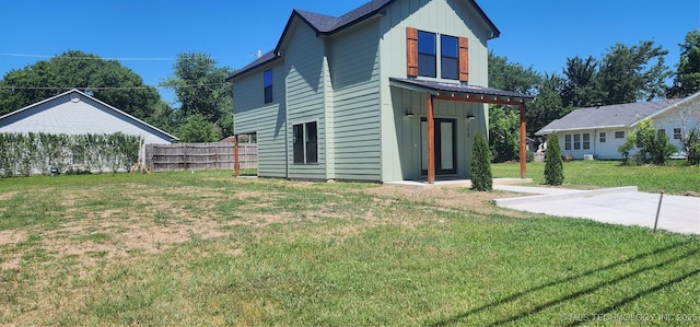 rear view of house featuring a lawn