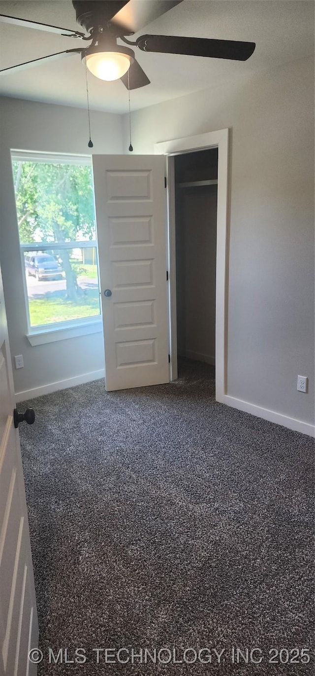 unfurnished bedroom with ceiling fan, a closet, and carpet floors