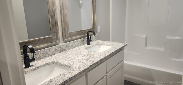 bathroom with bathing tub / shower combination and vanity