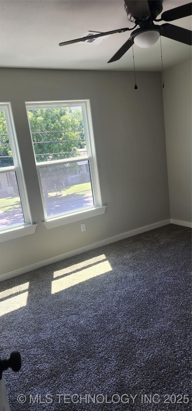 carpeted empty room featuring ceiling fan