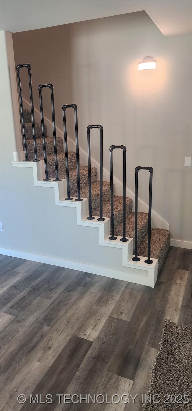 stairway with hardwood / wood-style floors